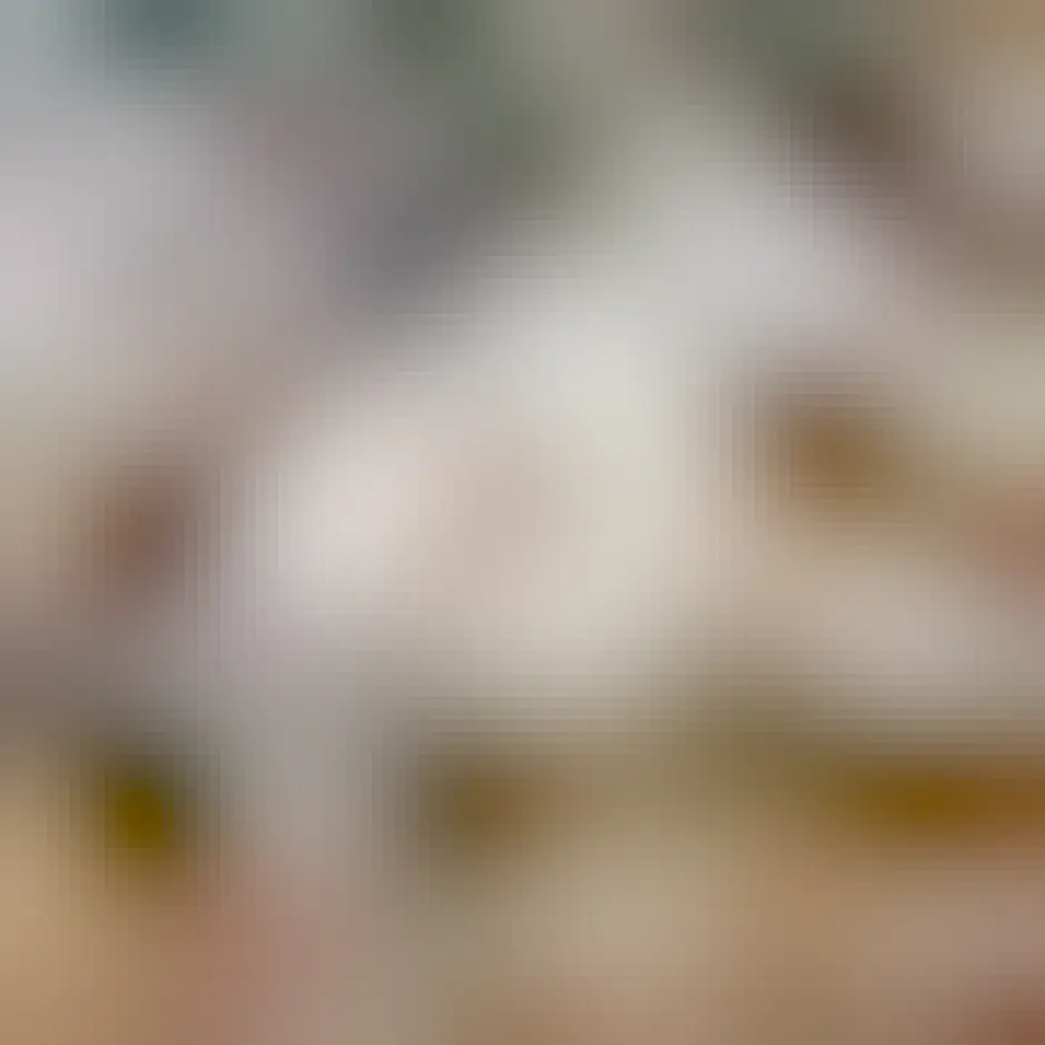 A handsome cat spread out over crumpled packing and tissue paper, looking pretty pleased with himself 