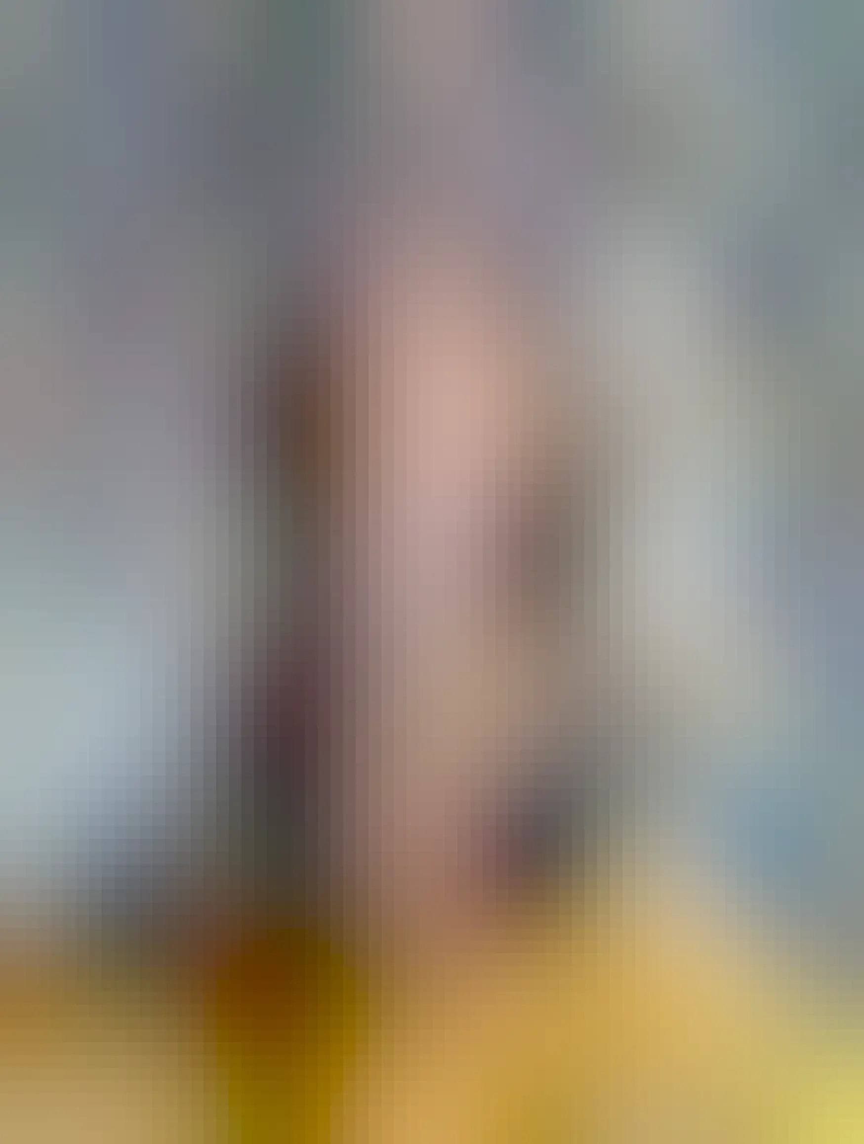 Man with aviator specs and mid length grey hair looking rather unenthused