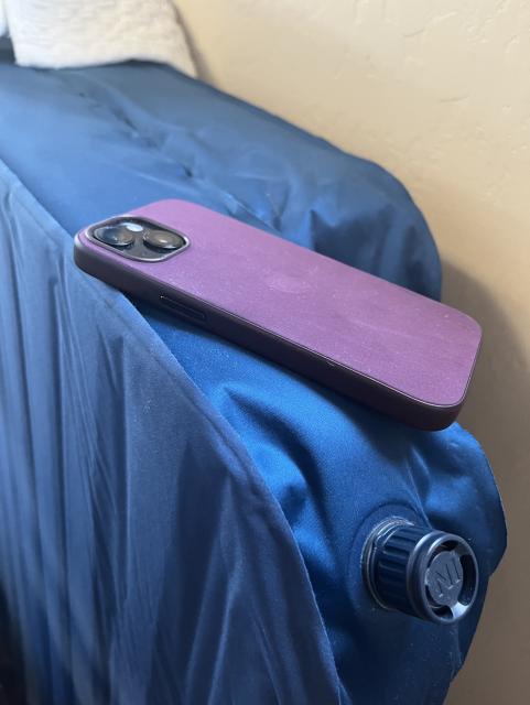 An iPhone 15 in a FineWoven case laying on top of a Thermarest camping mattress. They look and feel similar. 