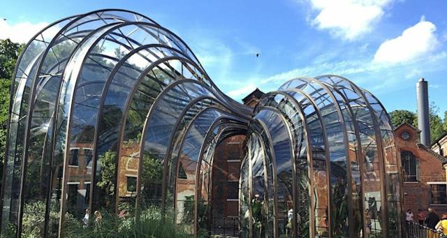 The Bombay Sapphire Gin Distillery in London featuring waves of glass as an extension on the front of a red brick building