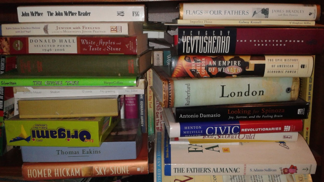 Photo: Two piles of books, somewhat well-balanced.