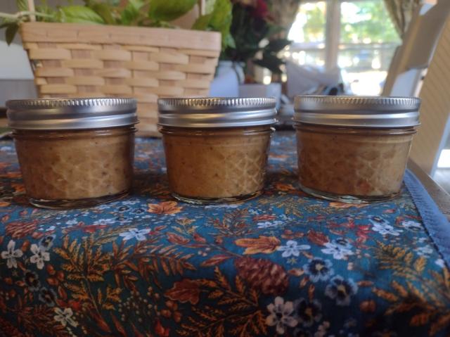 Three small jars of hot sauce lined up on our table