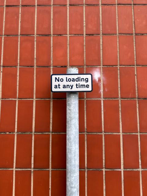 Street sign saying “No loading at any time”