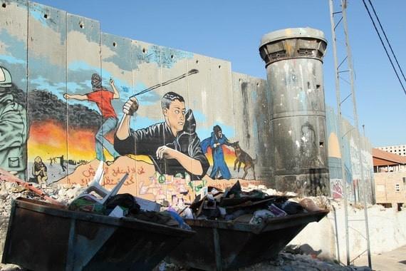 Graffiti covers an Israeli wall and guard tower in Aida Refugee Camp. Photo by Bryan MacCormack of Left in Focus.