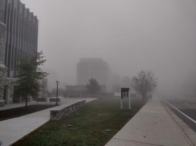 Campus buildings surrounded by dense fog