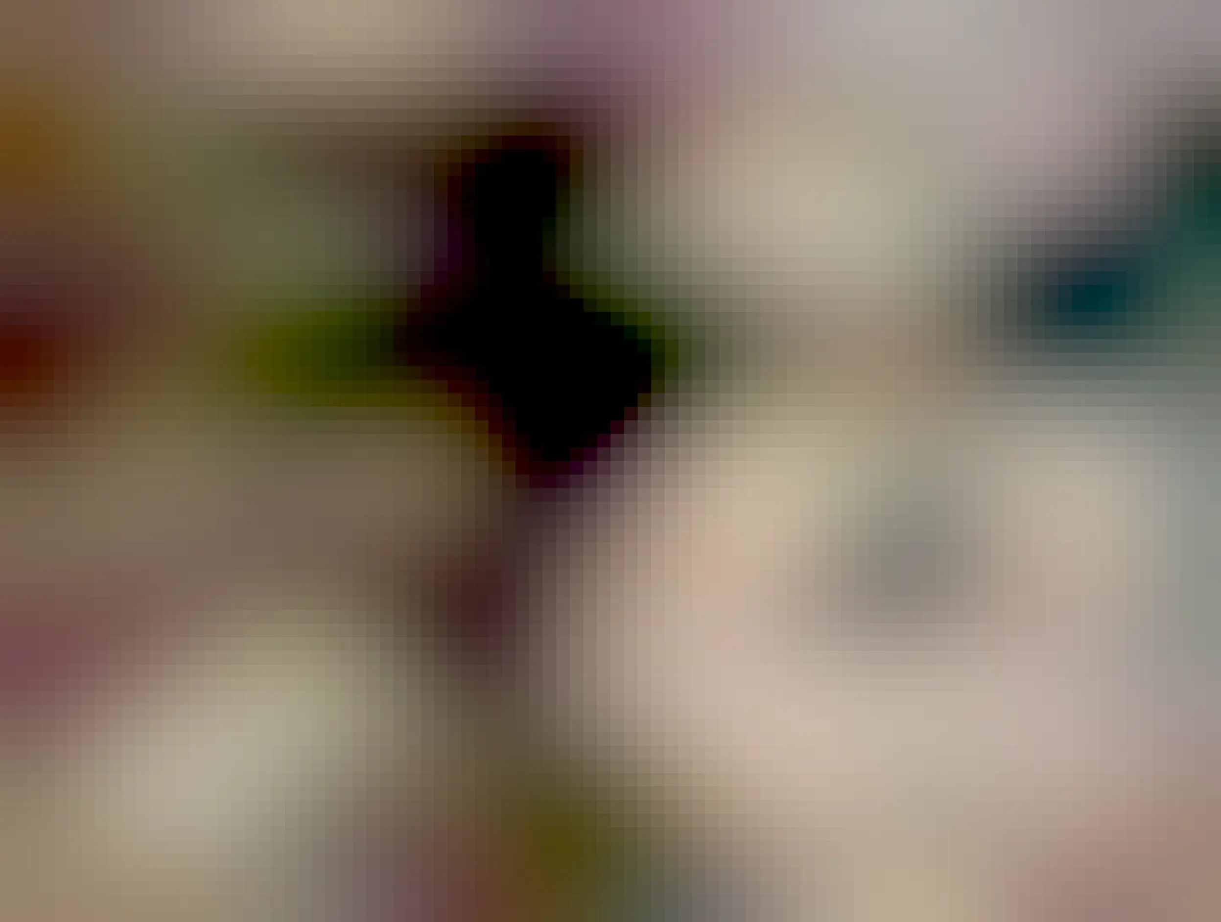 mouse peeking out from some rocks 