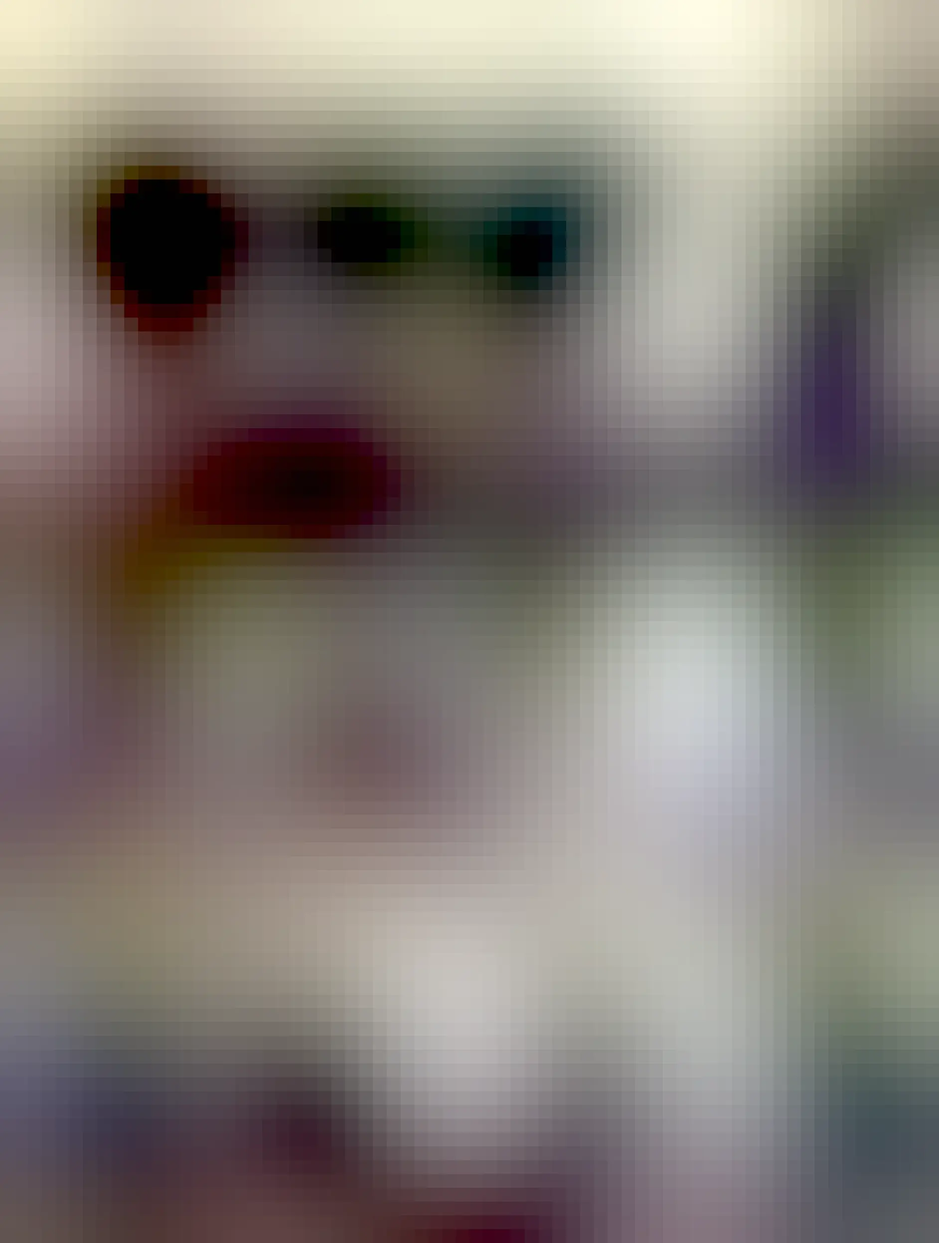 Henri is in the foreground, a tabby with almond shaped eyes, barely awake, with a look that’s somehow restful and menacing. Tiana is a black greyhound with a salt and pepper muzzle, out of focus behind him, looking off in the distance with her head resting against a blanket.