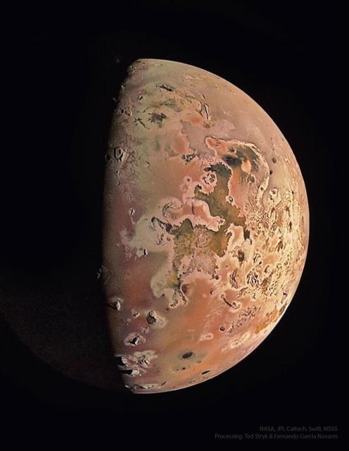 Jupiter's moon Io is shown as photogaphred recently by NASA's passing Juno spacecraft. The moon is nearly half- lit by the distant Sun and shows a complex surface including the colors yellow, orange, and dark brown. Near the top, the plume of an active volcano can be seen.