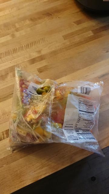 A picture of trader joe's frozen peppers with a small round hole in the middle of the back of the bag--not the corner, not an edge and rolled up, a random location.