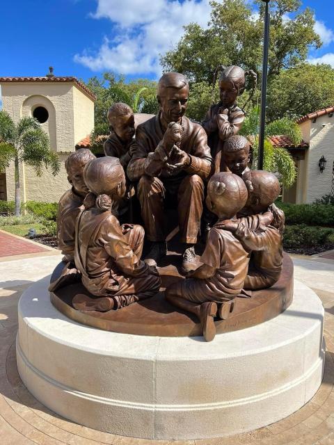 Mister Rogers sculpture. He is surrounded by children.