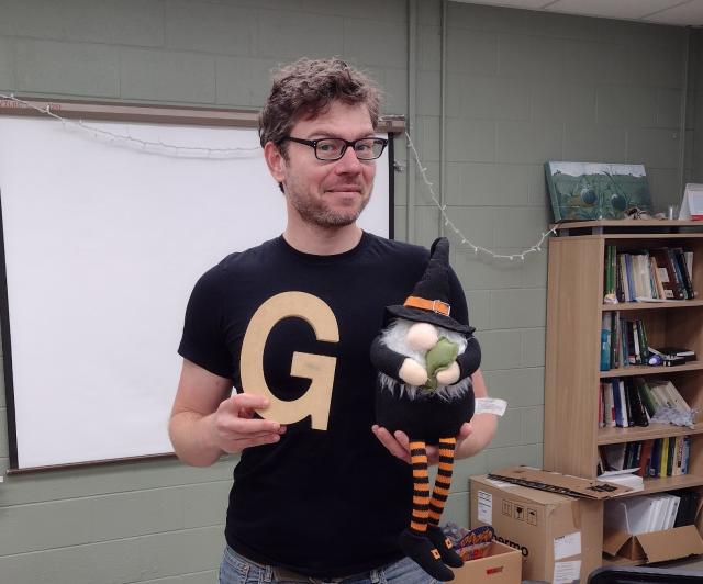 Frank holding the letter G and a gnome