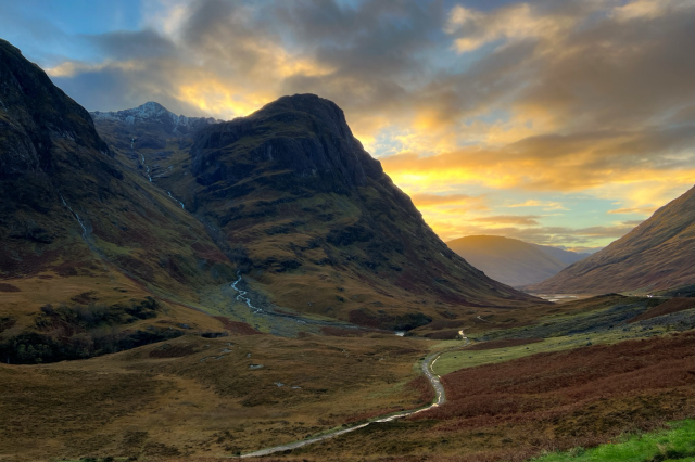 A photo of the mountains outside of Glencoe, Scotland at sunset. 