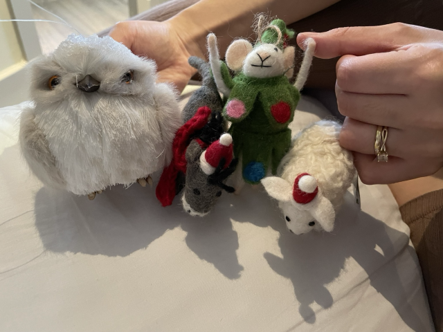 Felt baubles of a grey donkey in a Santa hat and scarf, a white mouse dressed like a Christmas tree, and a white sheep in a Santa hat, as well as a solid owl bauble.