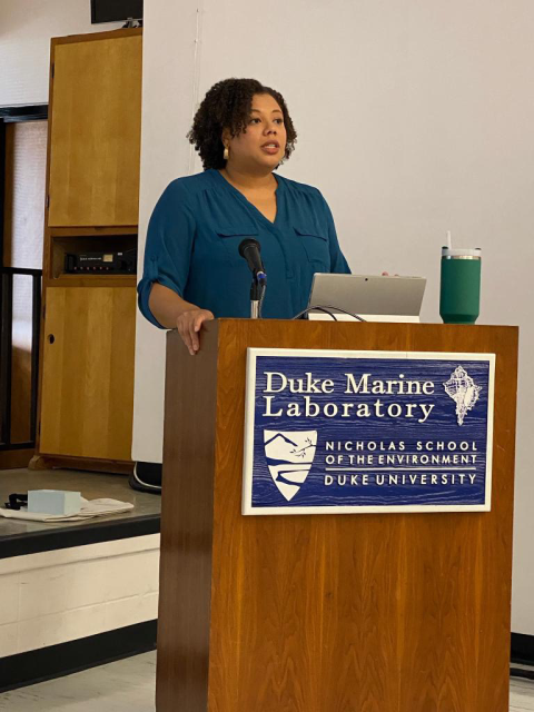 Imari speaking behind a podium at the duke marine lab 