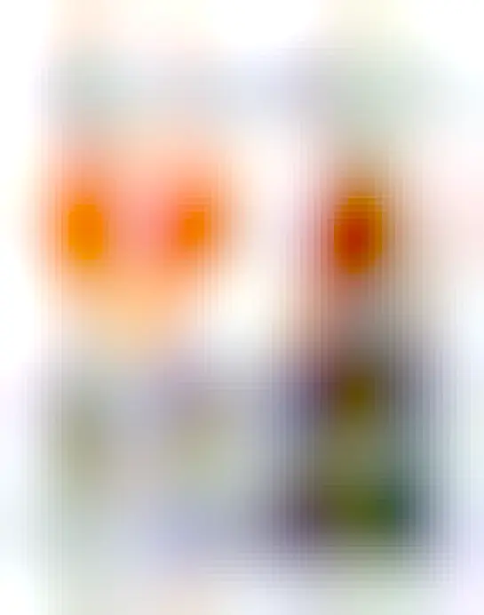 Tweet by @TheBeerShopper with phto of an amber-colored liquid in a red wine glass next to a brown beer bottle with purple labels with gold text and decoration in an Islamic art-influenced style. Label says "Loura 3.2% vol alc. Moura cerveja de alfarroba. Carob beer."  Both glass and bottle are on a white tablecloth and backlit in a clearly sunny vacation spot. Text of tweet says "Another first for me, Carob beer from in Portugal. Tasty. Now have to Google what the hell Carob is."