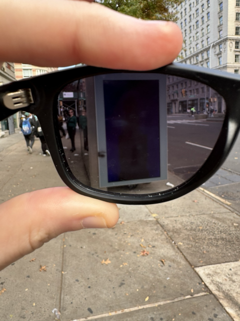 The billboard blocked by sunglasses.