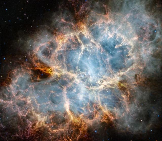 The Crab Nebula, M1, is shown as imaged by the James Webb Space Telescope. The rollover image is the same Crab Nebula but this time from the Hubble Space Telescope. The Webb image is in near infrared light, while the Hubble image is in visible light.