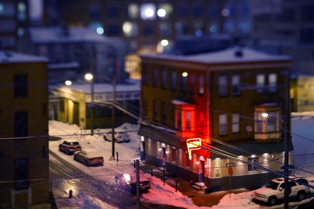 A corner bar, seen from above, selectively focused in a way that makes it appear to be of a miniature model.