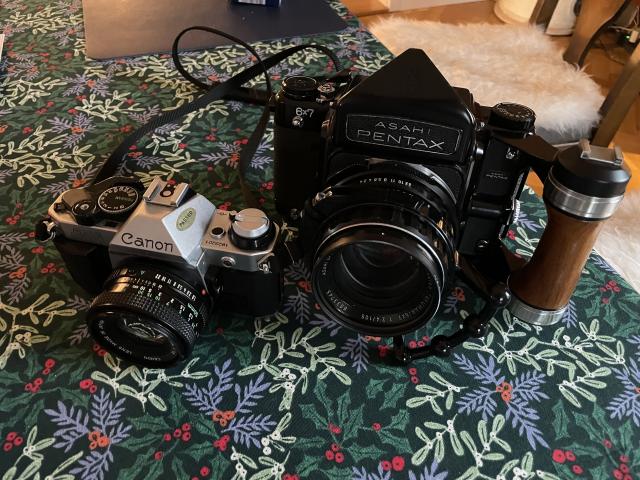 A Canon AE-1 next to a Pentax 6x7, which is much larger. 