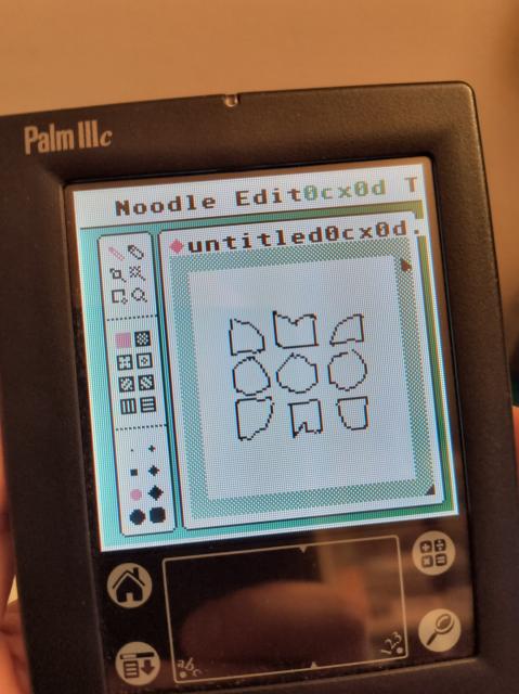 A Palm IIIc PDA showing the Uxn Noodle drawing app with the Merveilles logo.