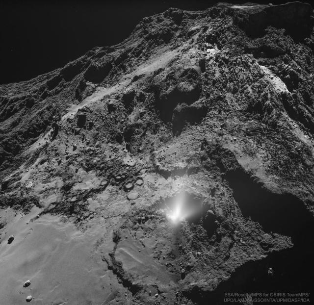 A dark and jagged hill is shown strewn with rocks. On the slope is a white foggy area that appears to emanate from a non-descript place on the rock face.