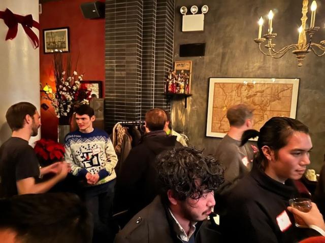 A photo taken at our Design Friends meetup in a cozy bar in Manhattan. Designers are gathering and chatting over cocktails. 