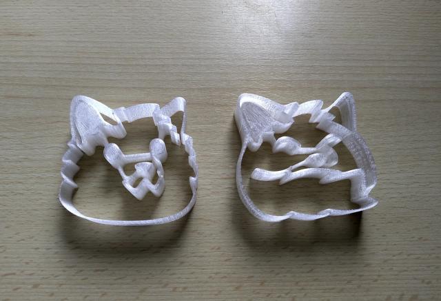 Two blob fox shaped cookie cutters printed in transparent filament.