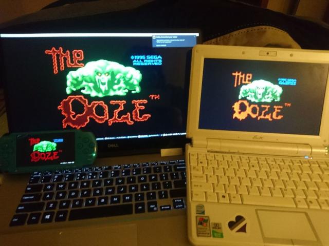 two laptops and a PSP displaying the ooze title screen