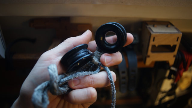 Two sailing rings with dyneema ropes dangling.