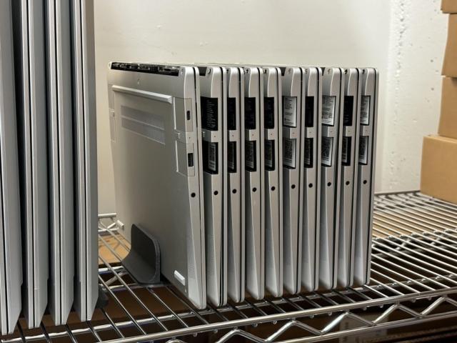 A stack of laptops in the storage closet at Framework.