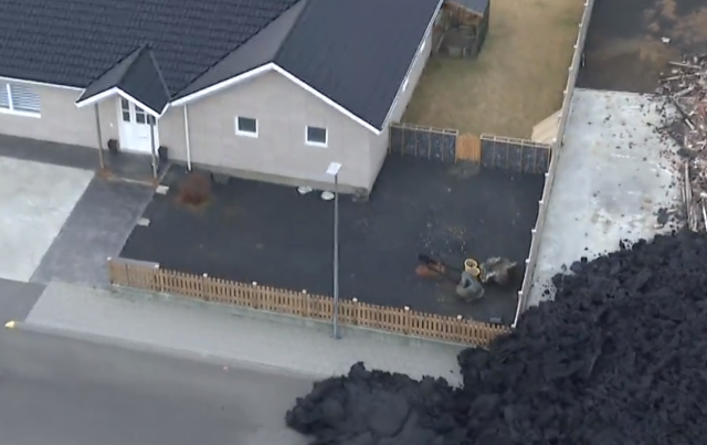 fence in iceland holding back a bit of lava