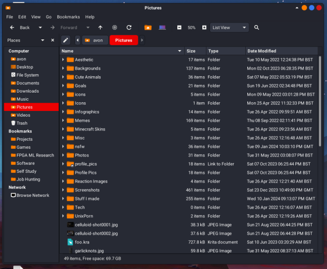 A view of Caja with the flat remix dark orange theme, showing my Pictures folder.