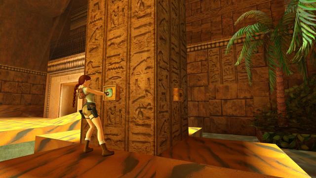 Screenshot of Lara Croft pushing a button in some sort of Egyptian temple
