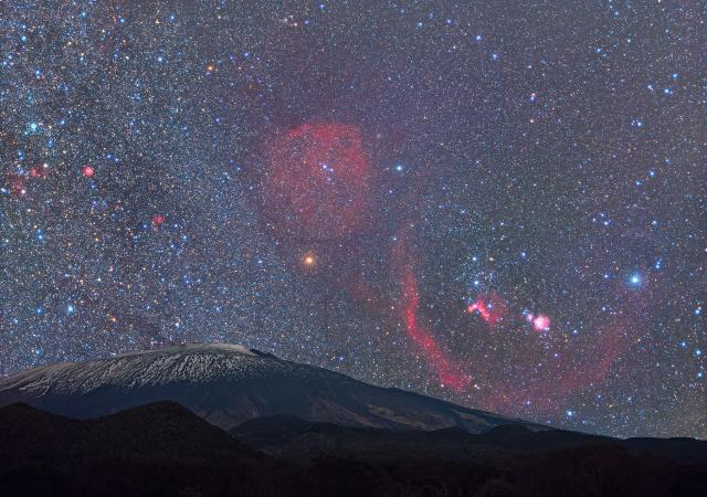 "Orion Rises Over Mount Etna."

Dario Giannobile/IAU OAE, CC BY 4.0, via Wikimedia Commons.