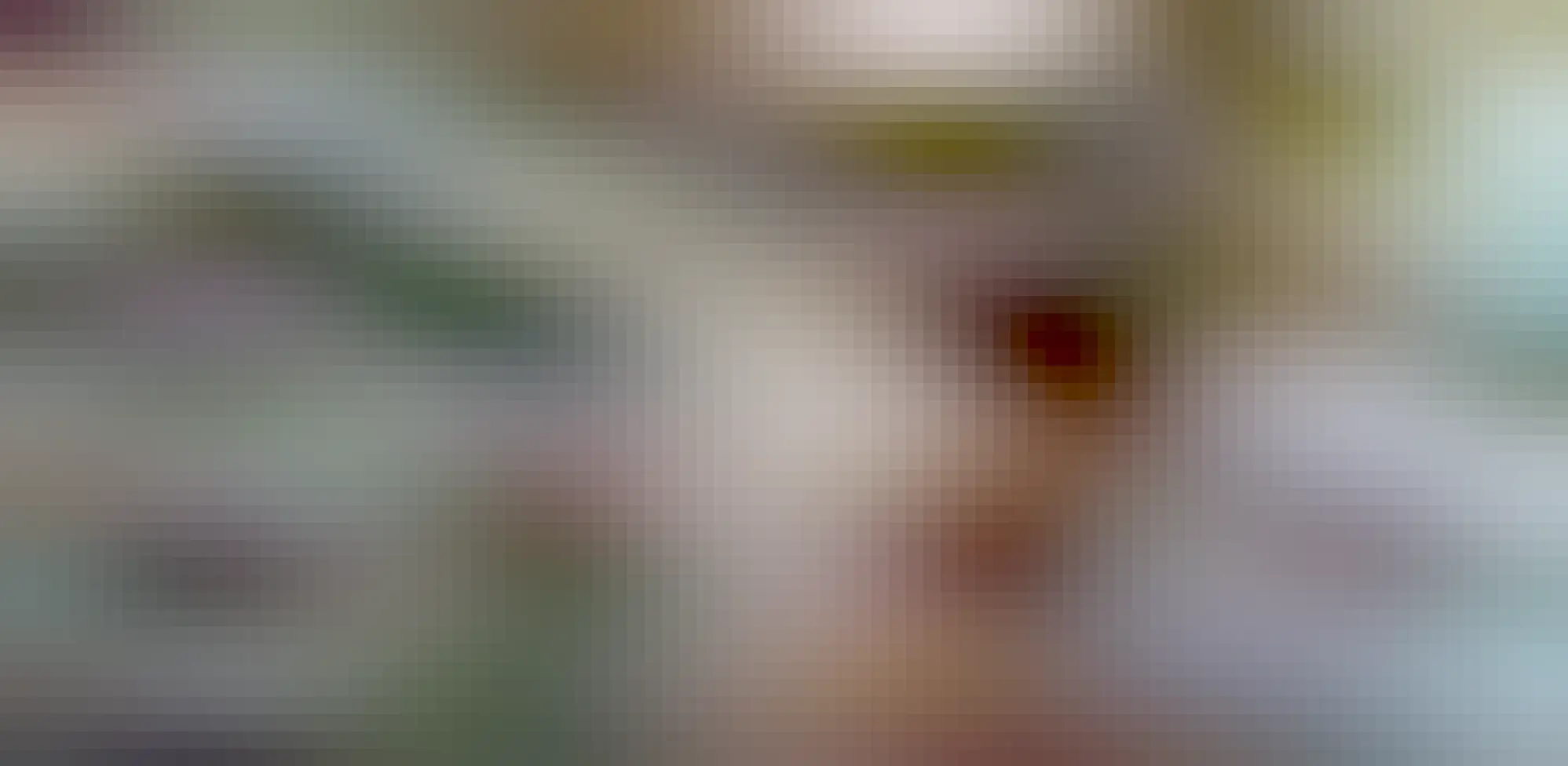 A wide shot of six of the geometric shapes in an art studio. They are large, around a matre across, and painted black and white. Tools are visible also.