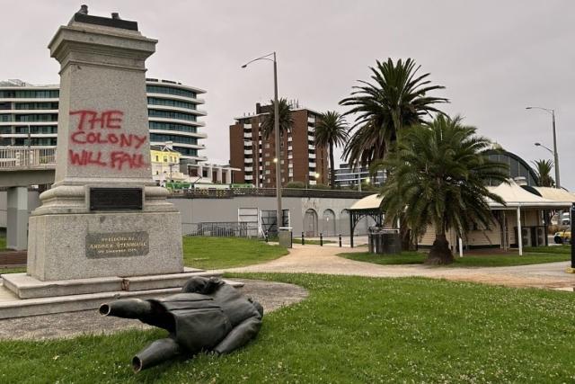 The statue of Colonizer Captain Cook in St Kilda, Melbourne toppled with "The colony will fall" spray painted on its concrete base.