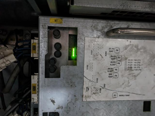 photo of the pm6-600 low voltage power supply section, closeup of status indicator leds. they're all green.