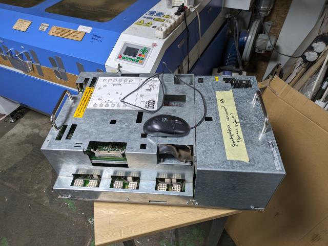 a kuka pm6-600 servo drive on a table. mouse for scale.