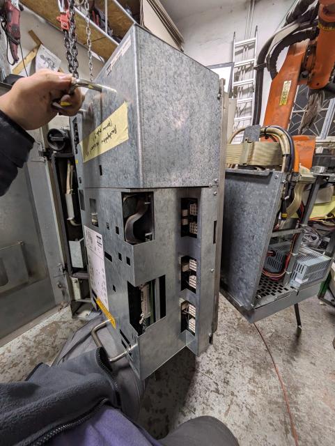 a kuka pm6-600 servo drive that I'm balancing on my knee right after pulling it out of the enclosure.