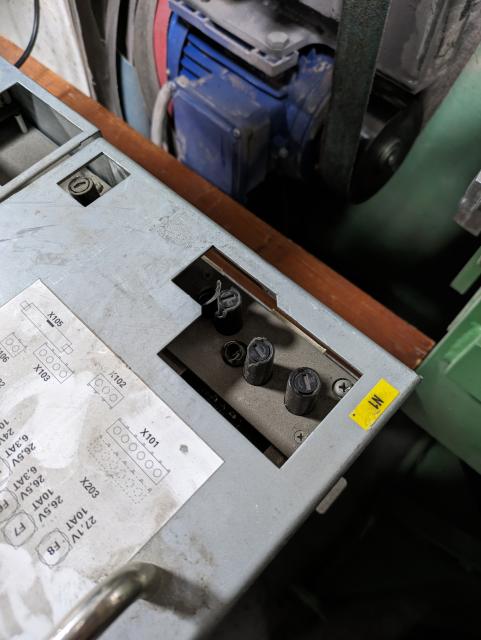 closeup photo of a broken pm6-600 with some fuse holders torn off.