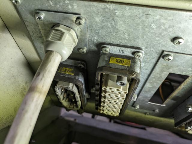 photo of the underside of krc1 connector panel showing the original harting han series power connector and the new cable coming in through a cable gland.