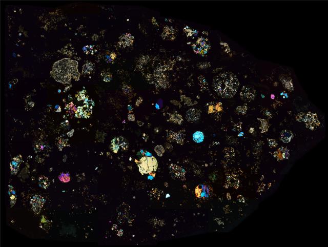 Thin section of NWA 2364 in cross polarized light. This meteorite has inclusions with age 4.5682 billion years.

Solar Anamnesis, CC BY-NC-ND 2.0 via Flickr: https://flic.kr/p/ZNipeW