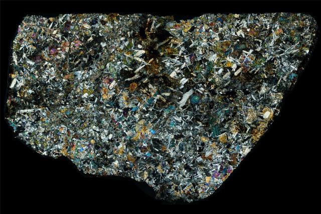 Thin Section of the Northwest Africa (NWA) 5903 Meteorite in cross polarized light.

Solar Anamnesis, CC BY-NC-ND 2.0 via Flickr: https://flic.kr/p/21fkS9r