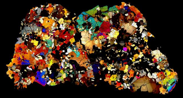 Thin Section of the Northwest Africa (NWA) 4590 Meteorite in cross polarized light.

Solar Anamnesis, CC BY-NC-ND 2.0 via Flickr: https://flic.kr/p/PYS2L9
