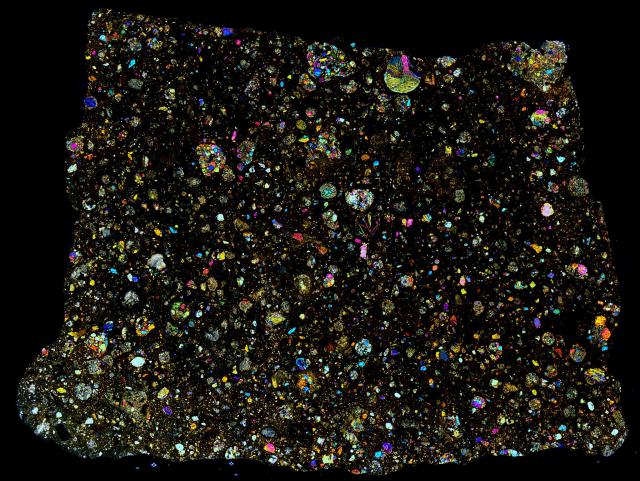Thin Section of the Northwest Africa (NWA) 5426 Meteorite in cross polarized light.

Solar Anamnesis, CC BY-NC-ND 2.0 via Flickr: https://flic.kr/p/N4sh5v