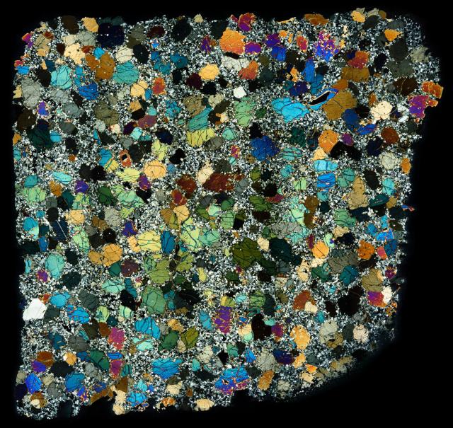 Thin Section of the Northwest Africa (NWA) 4587 Meteorite in cross polarized light.

Solar Anamnesis, CC BY-NC-ND 2.0 via Flickr: https://flic.kr/p/X3zrPs
