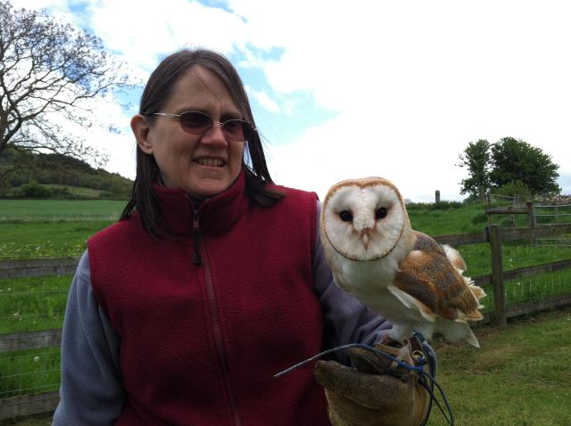 Middle-aged white woman holding a barn owl.
