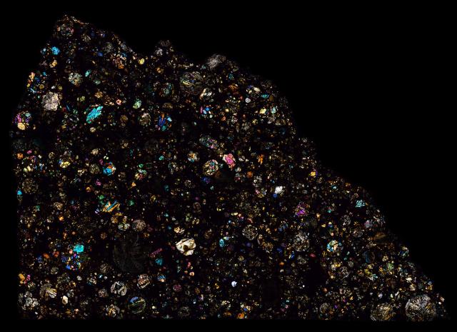 Thin Section of the Northwest Africa (NWA) 11038 Meteorite in cross polarized light.

Solar Anamnesis, CC BY-NC-ND 2.0 via Flickr: https://flic.kr/p/YCgo5U