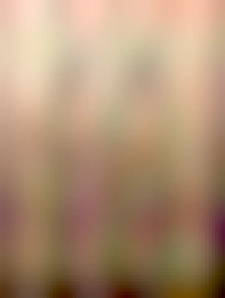 A photo of a punched paper tape used in data processing and programming of early computers. The punched paper tape has some of its holes patched up.