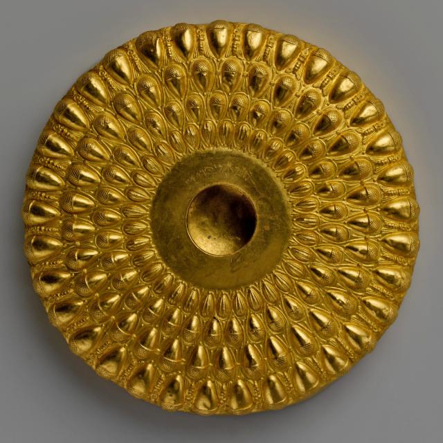 Greek Gold phiale (libation bowl).

Met, Public domain via https://www.metmuseum.org/art/collection/search/255122 Color and cropping edits.
